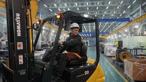 A forklift driving through a mining equipment repair plant. Stock Footage 145488663