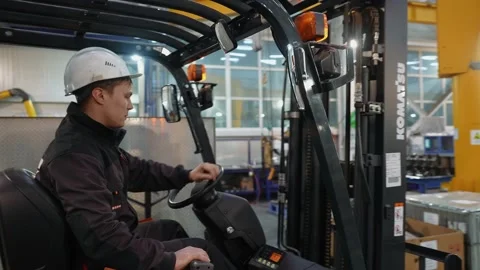 A forklift driving through a mining equipment repair plant. Stock Footage 145488789