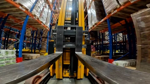 Forklift fork close-up. The load lifter rides on the warehouse pov. Modern Stock-Footage 203714618