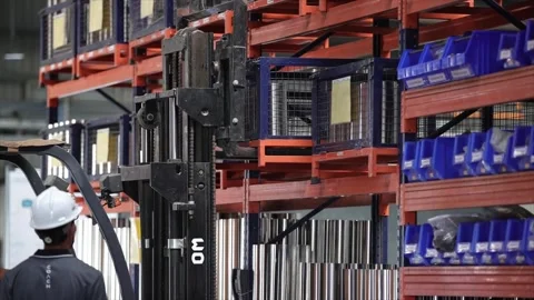 A Forklift Fork Engaging with a Caged Industrial Storage Bin on an Upper Stock-Footage 328387445
