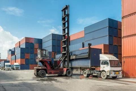 Forklift handling container box loading at docks with truck for Logistic Impo Stock Photos