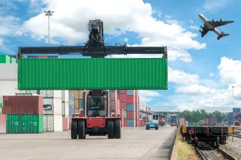 Forklift handling container box loading to freight train Stock Photos