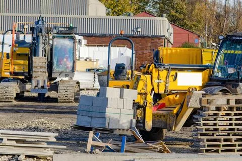 Forklift lifting and moving bricks on a pallet on a construction site. Movi.. Stock Photos