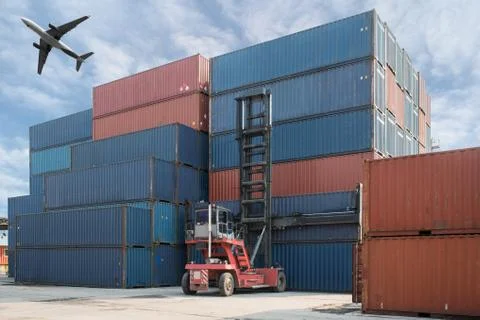 Forklift lifting container box loading to container depot with cargo airplane Stock Photos