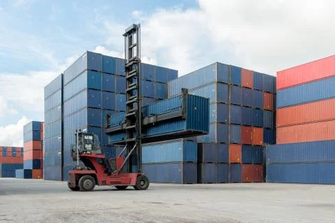 Forklift lifting container box loading to container depot use for cargo impor Stock Photos