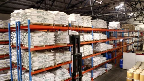Forklift Lifting Pallet With Sacks Of Rubber Chemicals Onto The Rack 库存影片 248742014