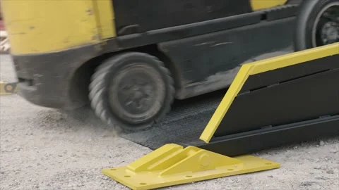 Forklift Loader Goes up Ramp To Load truck trailer equipment outdoors at factory Stock Footage 136715698