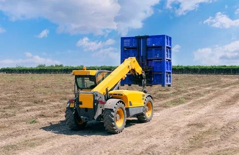 Forklift loader loads plastic containers. Stock Photos