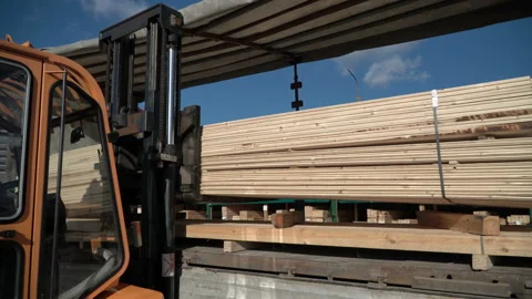 Forklift is loading wood planks into the truck Stock Footage
