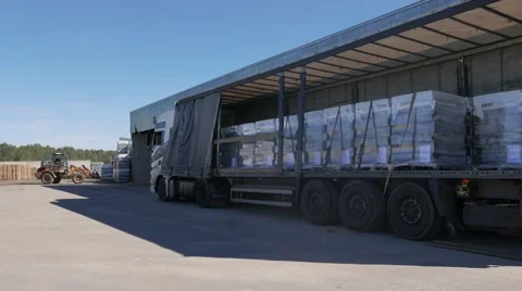 Forklift loads the truck with pallets of finished concrete products Stock Footage