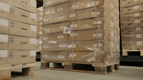 Forklift in a logistics warehouse picks up pallets of product from the floor. A  Stock Footage 37047685