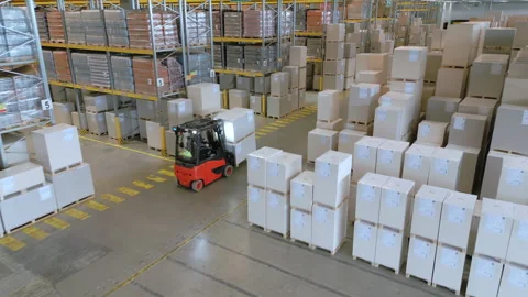 Forklift navigates warehouse aisles, loading cargo. 動画素材 308000044
