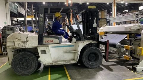 Forklift operating inside a factory Stock Photos