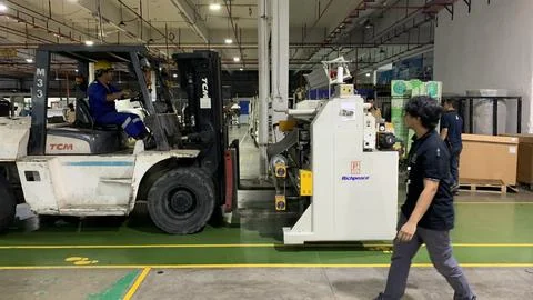 Forklift operating inside a factory Stock Photos