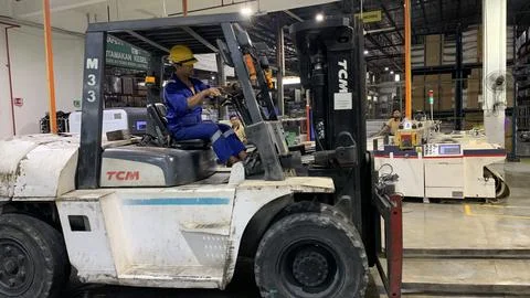 Forklift operating inside a factory Stock Photos