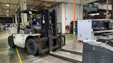 Forklift operating inside a factory Stock Photos