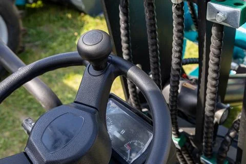 Forklift operator controls with steering wheel and gauge cluster Stock Photos
