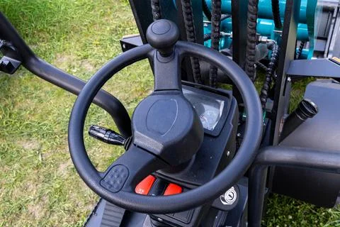 Forklift operator controls with steering wheel and hydraulic levers Stock Photos