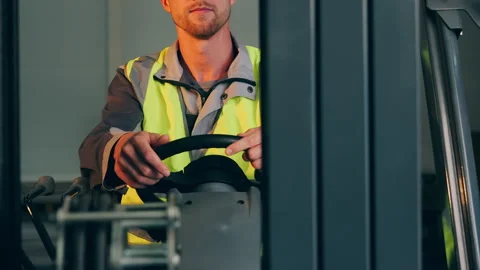 Forklift Operator Driving and Controlling Industrial Vehicle. Видео 345314704