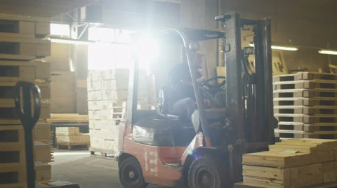 Forklift operator is driving in lumber factory warehouse Stock Footage 62545869