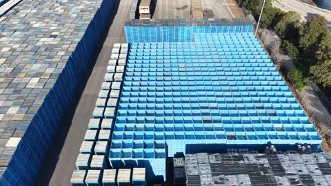 Forklift operator moving blue agricultural bins in a recycling yard Stock-Footage 339304531