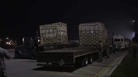 Forklift operator places a small container on a flatbed trailer Stock Footage 113345120