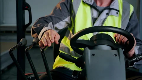 Forklift Operator Pulling Down Control Lever During Warehouse Operation. Stockbeeldmateriaal 345013032