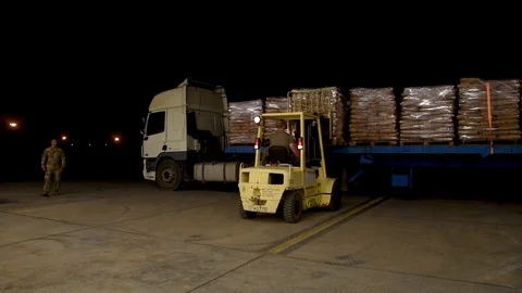 Forklift operator removes pallets of US Aid Stock Footage 113344133