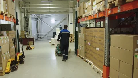 Forklift operator in special uniform is pulling the batch of packaged containers Stock Footage 200855857