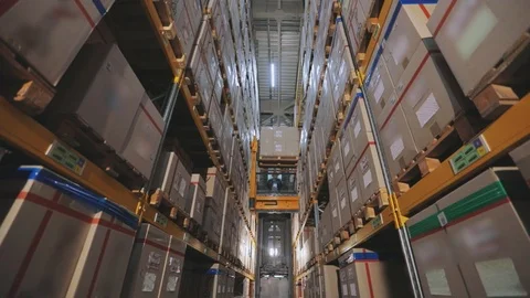 Forklift rearranges boxes at warehouse, large industrial warehouse, movement of Видео 126419984