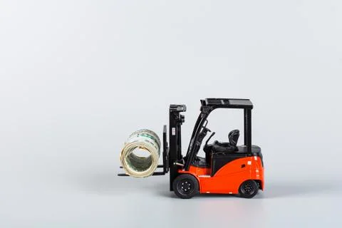 Forklift with roll of dollars on gray background. Strongest financial assista Stock Photos