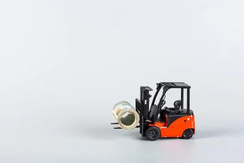 Forklift with roll of dollars on gray background. Strongest financial assista Foto stock