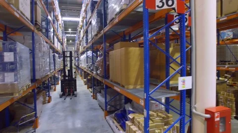 Forklift trucks goes between warehouse shelves in a modern storehouse with many 스톡 동영상 79793790