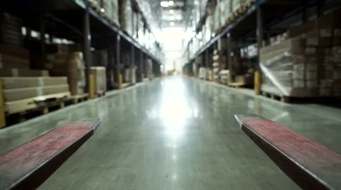 Forklift Trucks Move Between Large Metal Shelves at a Modern Warehouse Stock Footage