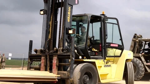Forklift trucks moving construction items at military field base in Israel  Stock Footage 104490160