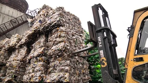 The forklift unloads the stack with extruded plastic bottles Stock Footage 84400514