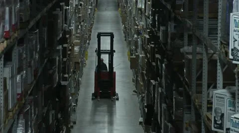 FORKLIFT IN WAREHOUSE AISLE Stock Footage
