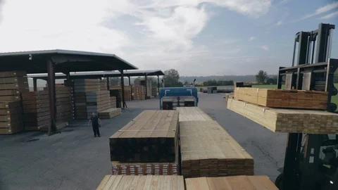 Forklifter loading treated lumber on flatbed trailer view from trailer Stock Footage 98040487