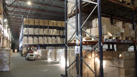 Forklifts in A Large Warehouse Are Doing The Job. Stock Footage 197334821