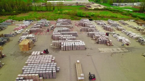 Forklifts working on yard with stacks of Pavers and Slabs, Permeable and Stockbeeldmateriaal 275231249