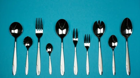 Forks and spoons of different sizes. Stop motion Stock Footage 88057788