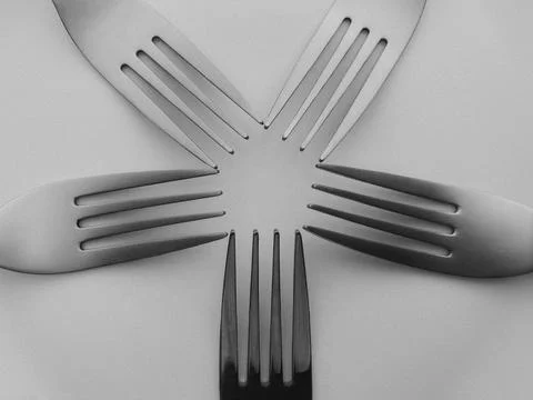 Forks arranged in circular pattern forming abstract symmetry 写真素材
