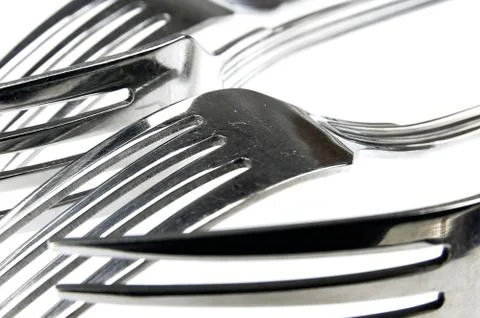 Forks arranged in series on the kitchen table Stock Photos