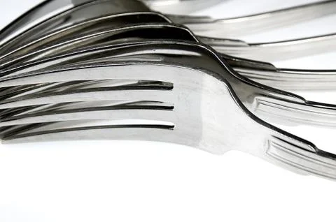 Forks arranged in series on the kitchen table Stock Photos
