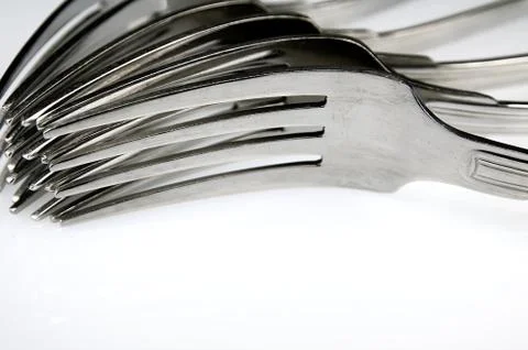 Forks arranged in series on the kitchen table Stock Photos