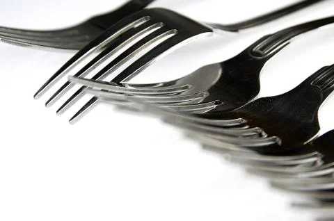 Forks arranged in series on the kitchen table Stock Photos