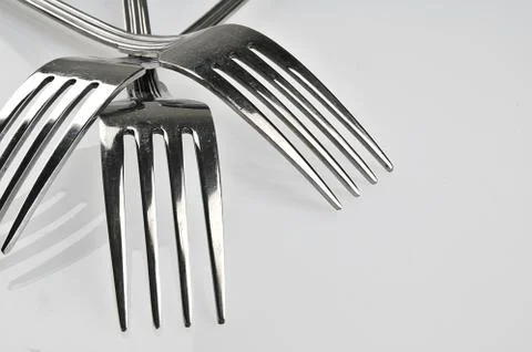 Forks arranged in series on the kitchen table Stock Photos