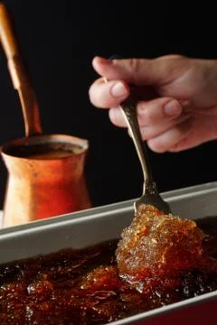 Form with a cold dessert on the table and a coffee maker side view Foto stock