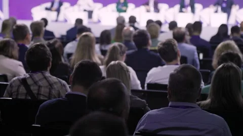 Formal conference setting with engaged professionals and stage lighting Vídeo Stock 327653429