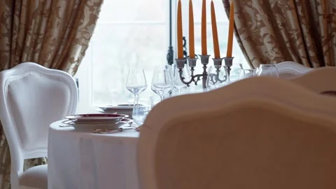 Formal dinner table setting with lit candles Stock Footage 332310794